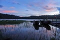 Wooden fishing boats in the lake. Blue sunrise sky colors over the lake in the early morning. Tranquil morning light view. Royalty Free Stock Photo