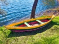 Wooden Fishing boats on shore of Galve lake Trakai Lithuania in spring. Old wooden boat in grass on the lake bank Royalty Free Stock Photo