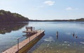 Wooden fishing and recreation platform at Lipie Lake on a sunny day, color toning applied, Poland