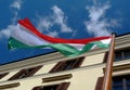 Wooden flag pole in diminishing perspective. red, white and green Hungarian national flag. blue sky