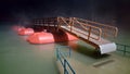 Wooden floating pontoon bridge surrounded with fog at night during flood Royalty Free Stock Photo