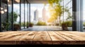 Wooden floor is in front of large window that overlooks cityscape with potted plants on either side of the window Royalty Free Stock Photo