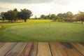 Wooden floor and golf course background. Fresh spring green golf course with wood floor. Beauty natural background, Empty wooden Royalty Free Stock Photo