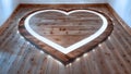 A wooden floor with a heart shape cutout with LED lights