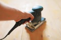 Wooden floor sanding with flat sander tool