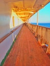 A wooden-floored passageway on a passenger ship sailing at sea