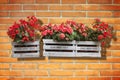 Wooden flowers boxes against an old brick wall - Home sweet home