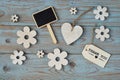 Wooden flowers and heart with calk board on a old wooden background with empty space layout Royalty Free Stock Photo