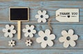 Wooden flowers and heart with calk board on a old wooden background with empty space layout Royalty Free Stock Photo