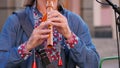 wooden flute. close-up. embroidered shirt. Street musician, in an embroidered shirt, plays on sopilka, wooden flute