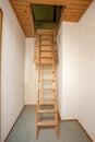 Wooden folding ladder to the attic, old empty house