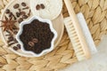 Wooden foot brush with pumice stone and homemade exfoliating foot scrub with ground coffee, star anise and clove. Natural pedicure