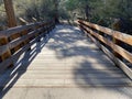 Wooden foot river bridge hiking trail shade trees sunny afternoon hike hillside mountain climb Royalty Free Stock Photo