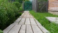 Wooden footbridge near a village house in Russia. Close up photo below