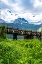 Wooden footbridge over stream against background of Meded Peak and Glacial Black Lake. Durmitor National Park. Montenegro