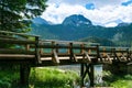 Wooden footbridge over stream against background of Meded Peak and Glacial Black Lake. Durmitor National Park. Montenegro