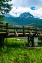 Wooden footbridge over stream against background of Meded Peak and Glacial Black Lake. Durmitor National Park. Montenegro