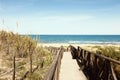 Wooden footbridge over dunes to the beach Royalty Free Stock Photo