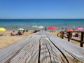 Wooden footbridge on the sandy beach in summer Royalty Free Stock Photo