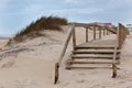 Wooden footpath through dunes at the ocean beach Royalty Free Stock Photo