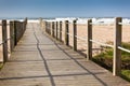 Wooden footpath through dunes at the ocean beach Royalty Free Stock Photo