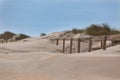 Wooden footpath through dunes at the ocean beach in Portugal Royalty Free Stock Photo