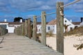 Wooden footpath through dunes at the ocean beach in Portugal Royalty Free Stock Photo