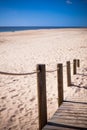 Wooden footpath through dunes at the ocean beach in Portugal Royalty Free Stock Photo