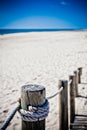 Wooden footpath through dunes at the ocean beach in Portugal