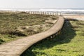 Wooden footpath through the dunes to the beach of praia de Silvalde , Portugal Royalty Free Stock Photo