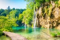 Wooden footpath at Plitvice national park, Croatia. Pathway in the forest near the lake and waterfall. Fresh beautiful nature, Royalty Free Stock Photo