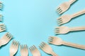 Wooden forks lie in a circle on a blue background