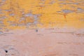 Wooden fragment with yellow and brown, peeling paint. Texture of wood and paint. Royalty Free Stock Photo