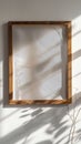 A wooden frame casting organic shadow patterns on the wall, creating a visually intriguing and moody backdrop for Royalty Free Stock Photo