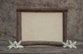 Wooden frame with flowers on the wooden table