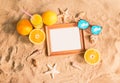 Wooden frame, glass of orange juice, sunglasses and seashells Royalty Free Stock Photo