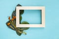 Wooden frame with green leaf and dry flower Royalty Free Stock Photo