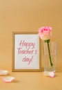 Wooden frame with greeting card text HAPPY TEACHERS DAY delicate pink roses on beige background. Minimal trendy