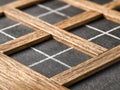 Wooden frame grid placed on a dark chalkboard surface with geometric white chalk lines creating a structured and textured visual Royalty Free Stock Photo