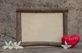 Wooden frame with heart on the wooden table