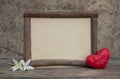 Wooden frame with heart on the wooden table