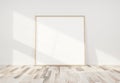 Wooden frame leaning in bright white interior with wooden floor mockup 3D rendering