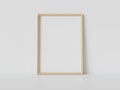 Wooden frame leaning on white floor in interior mockup. Template of a picture framed on a wall 3D rendering Royalty Free Stock Photo