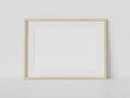 Wooden frame leaning on white floor in interior mockup. Template of a picture framed on a wall 3D rendering Royalty Free Stock Photo