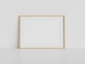 Wooden frame leaning on white floor in interior mockup. Template of a picture framed on a wall 3D rendering Royalty Free Stock Photo