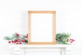 Wooden frame on a mantelpiece with branches - autumn theme Royalty Free Stock Photo