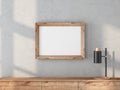 Wooden Frame Mockup hanging on concrete wall above bureau