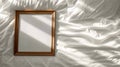 Wooden frame mockup picture on bed, top view, detail of bedroom interior with white blank poster, pillow and linen. Concept of Royalty Free Stock Photo