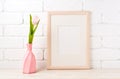 Wooden frame mockup with pink tulip in swirled vase