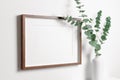 Wooden frame mockup on white wall with copy space for artwork, photo or print presentation. Royalty Free Stock Photo